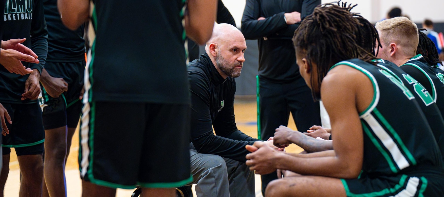 Head Coach Dan Burke calls a timeout and communicates with the team during their game against Georgian Court University Lions on Senior Night. Photo by Giovanni Badalamenti.