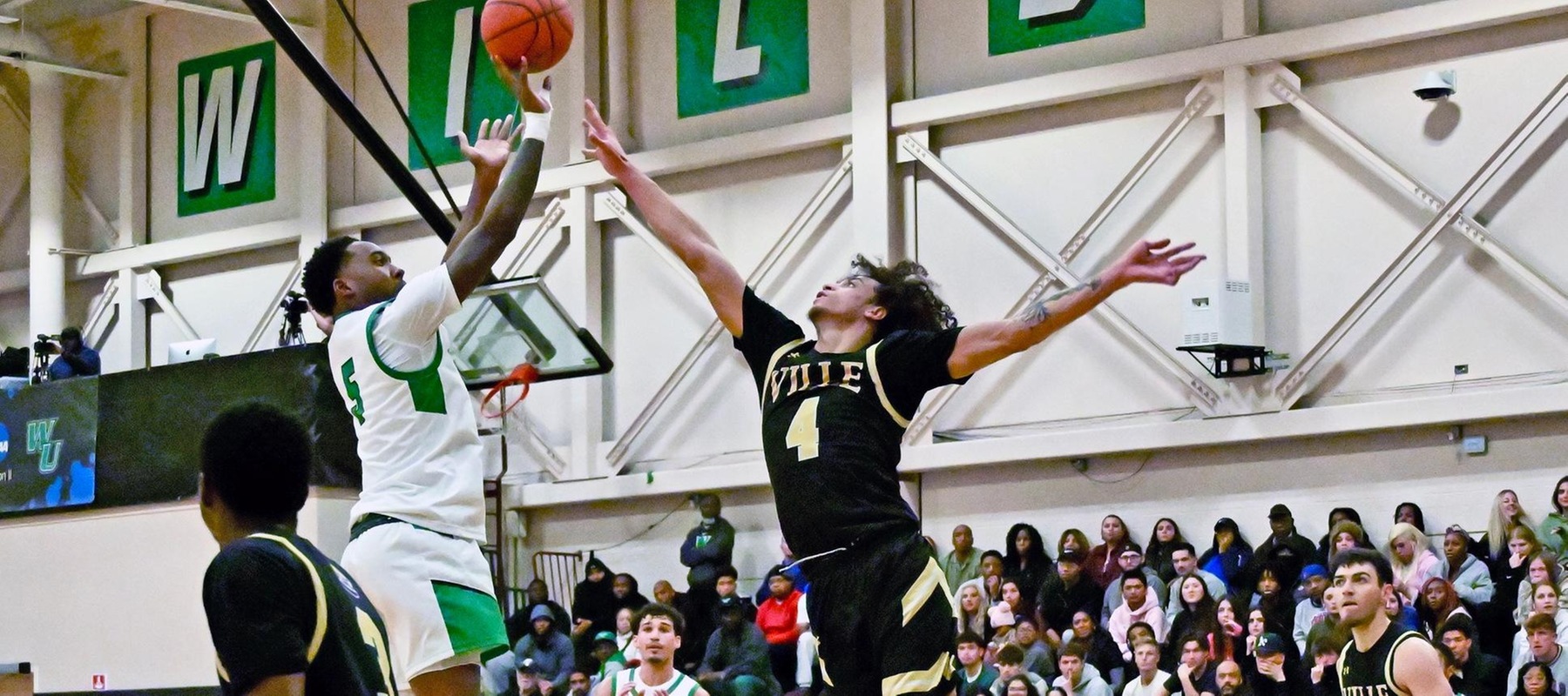 Photo of Akeem Taylor hitting a jumper against Millersville. He would score in 2OT to win it for WilmU. Copyright 2025; Wilmington University. All rights reserved. Photo by Joe Maciey. November 19, 2025 vs. Millersville.