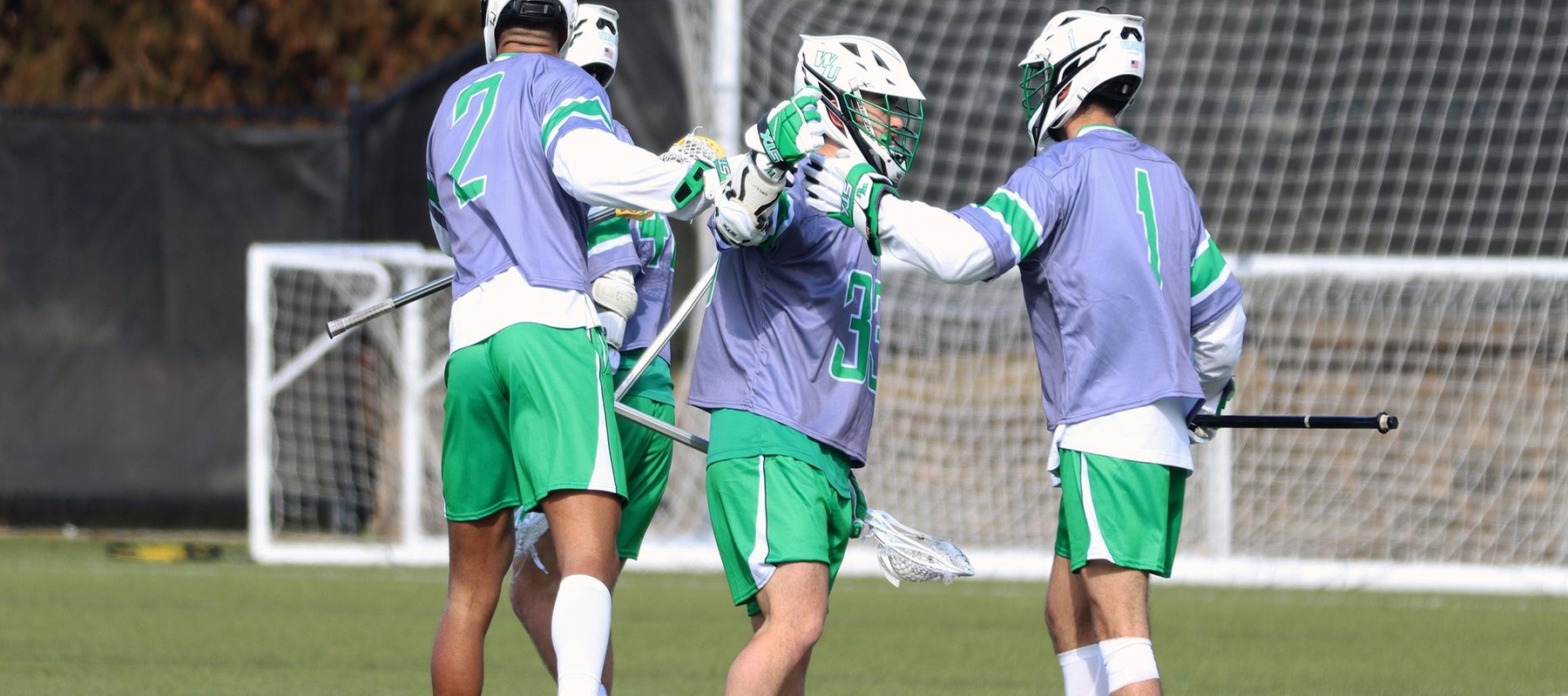 Photo of Giovanni Marino (33) and Miles Crouse (1) celebrating after Giovanni scored one of his seven goals on Saturday against Chowan. Photo by Mitchell Coll.