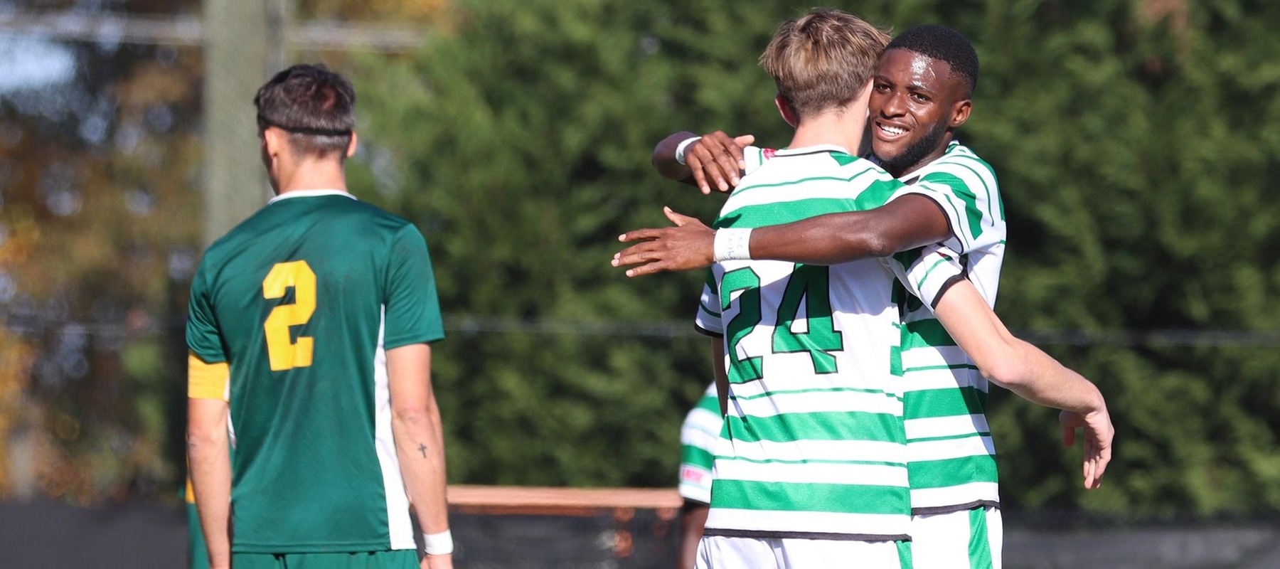 Photo of Shawn Genus (10) and Marcus Hedemann (24) celebrating following a goal. Copyright 2021; Wilmington University. All rights reserved. Photo by Trudy Spence. November 8, 2021 vs. Felician in CACC Tournament First Round.