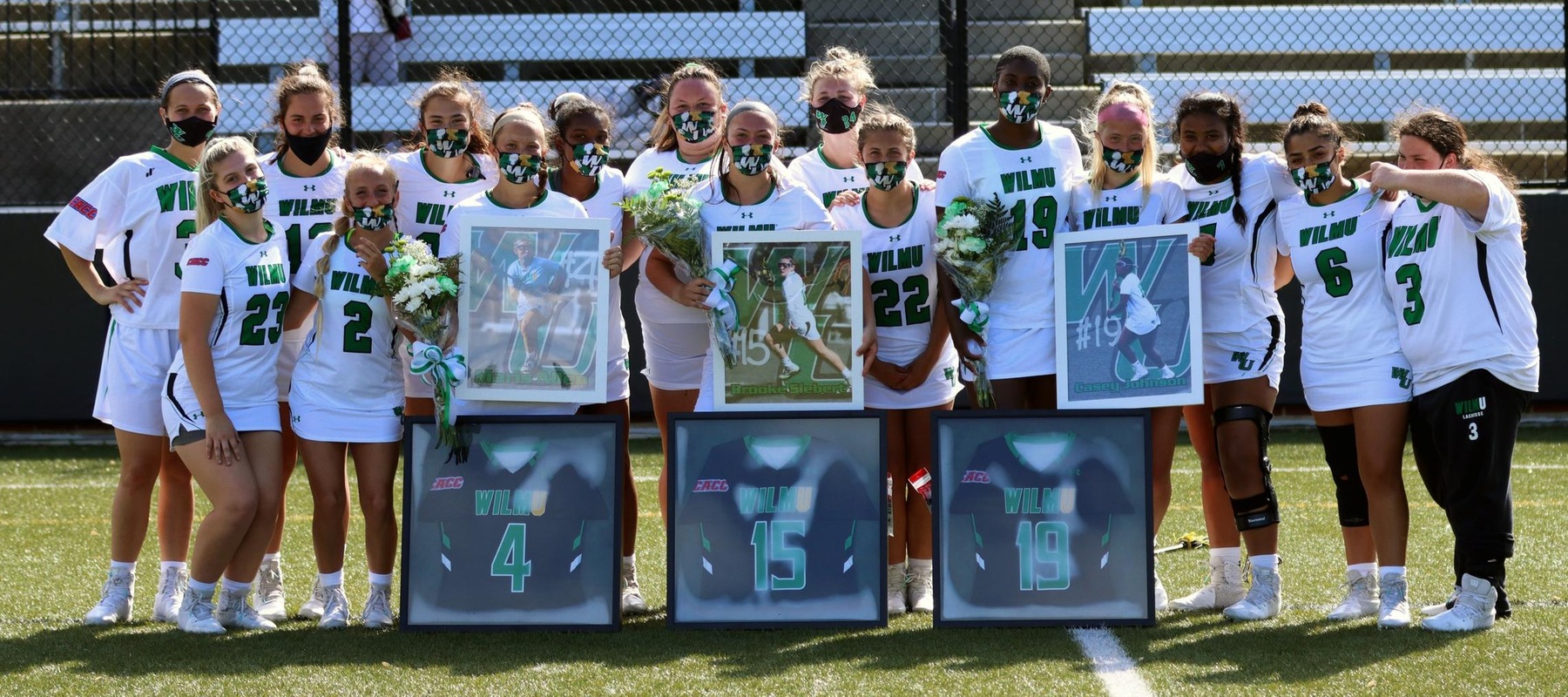 Photo of the team with the three seniors following the game against Holy Family. Brooke Siebert (15), Maris Allen (4), and Casey Johnson (19). Copyright 2021; Wilmington University. All rights reserved. Photo by Erin Harvey.