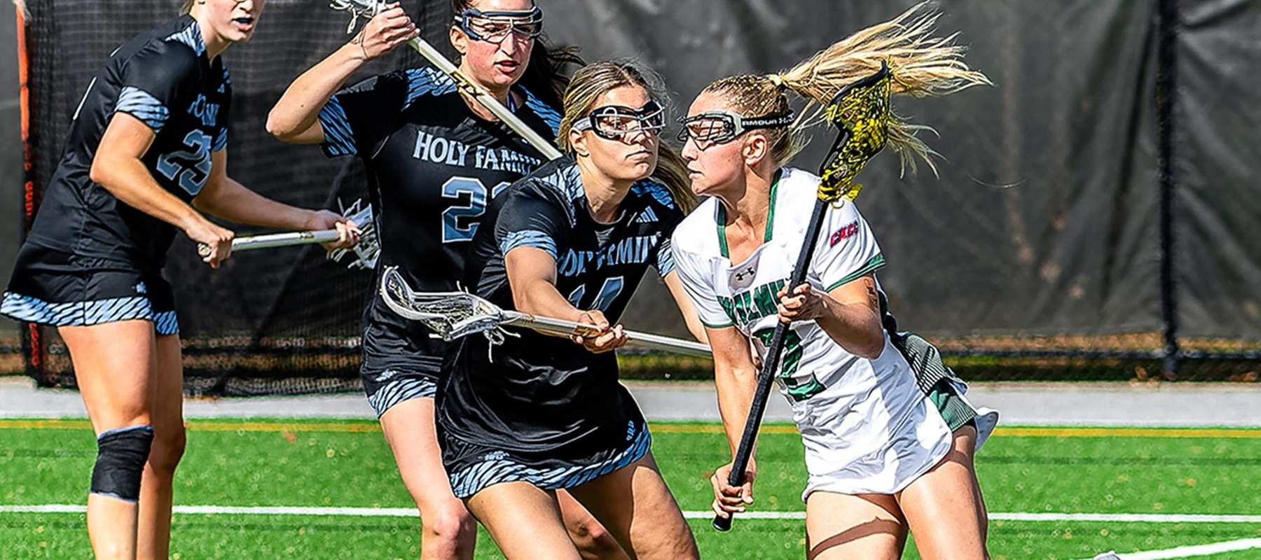 Wilmington University&rsquo;s Ella Royer (2) drives towards the goal in front of Holy Family University&rsquo;s Lexi Ryan (14) looks on during their NCAA Women's Lacrosse match at the Wilmington University Sports complex in Newark, Delaware, April 15, 2025. Photo By David Reeder