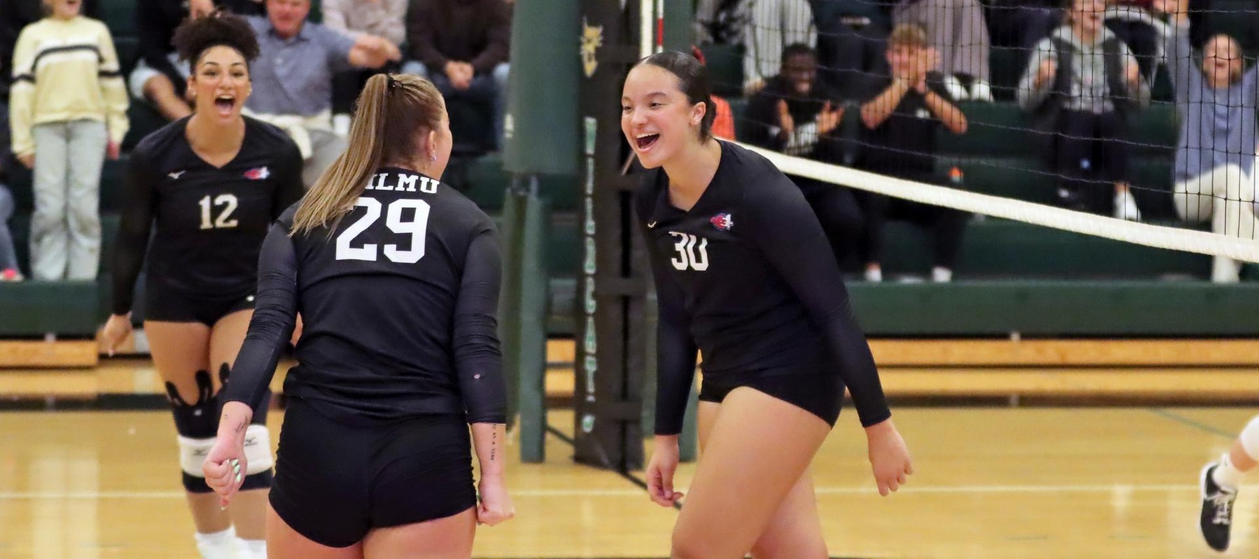 Photo of Gianna King (30) and Addison Hoover (29) celebrating after a block late in the fourth set against Goldey-Beacom. Copyright 2025; Wilmington University. All rights reserved. Photo by Dan Lauletta. October 15, 2025 vs. Goldey-Beacom.